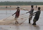 Fisherman pulling in their net at low tide in the Indian Ocean