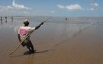 Fisherman at low tide in the Indian Ocean