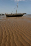 fishing boat and sand waves at low tide in the Indian Ocean